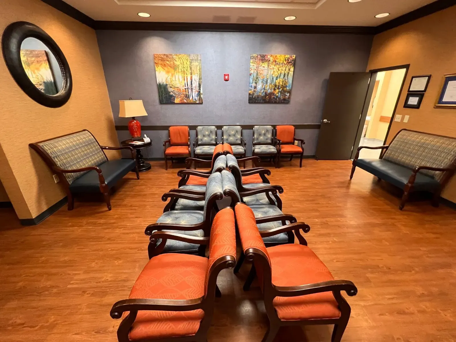 Cleaned medical office waiting room with orange chairs